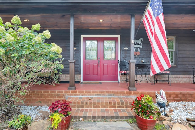 doorway to property featuring covered porch