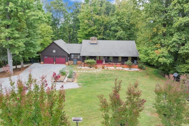 view of front of property featuring a front yard and a garage