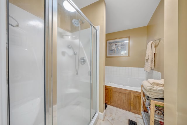 bathroom featuring separate shower and tub