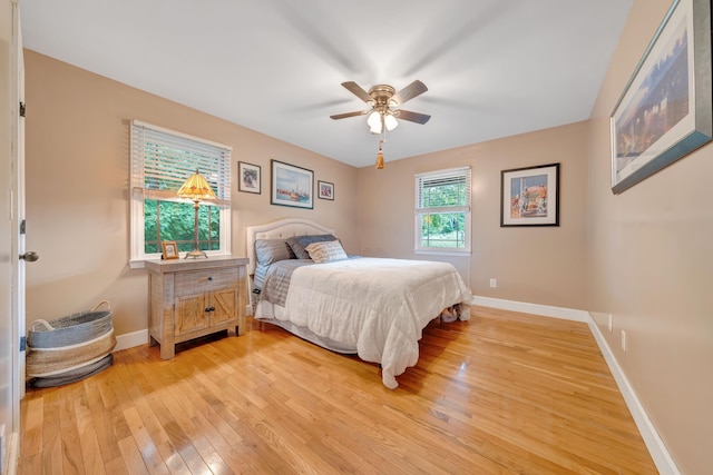 bedroom with light hardwood / wood-style flooring and ceiling fan