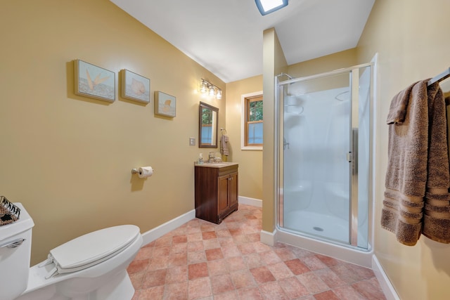 bathroom featuring vanity, toilet, and an enclosed shower