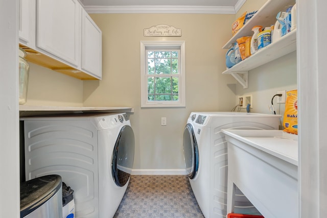 laundry area featuring crown molding, independent washer and dryer, and cabinets