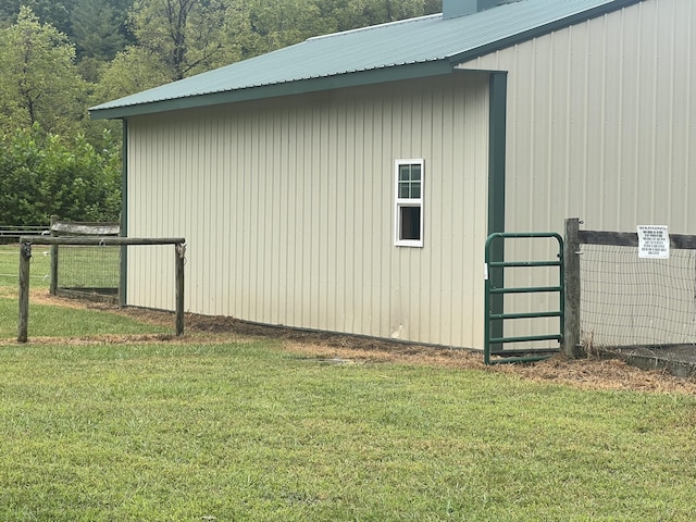 view of side of home with a lawn