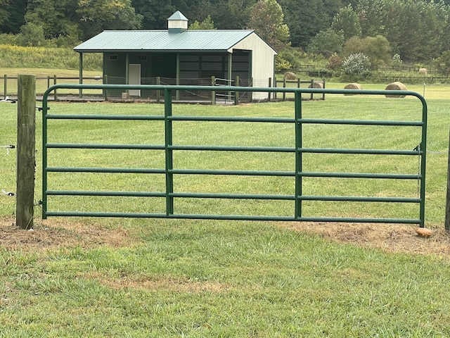 view of gate with an outdoor structure