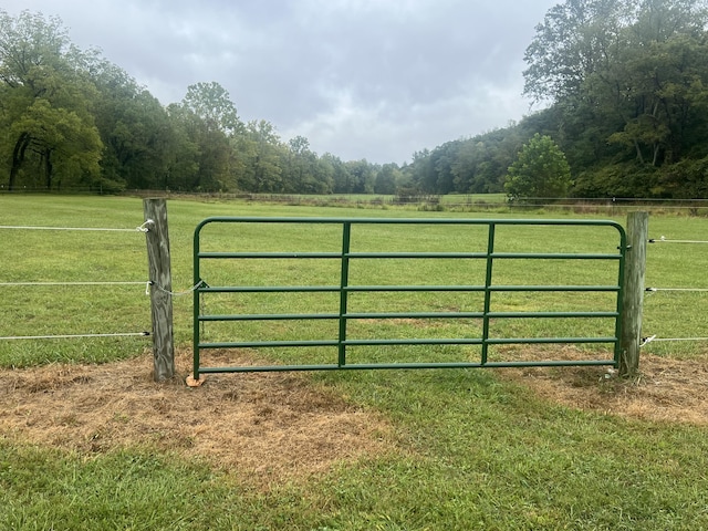 view of gate featuring a yard