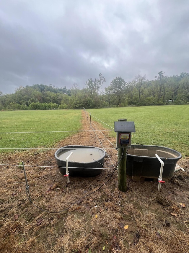 view of yard with a trampoline and a rural view