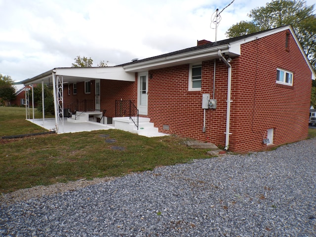 back of house featuring a yard and a patio