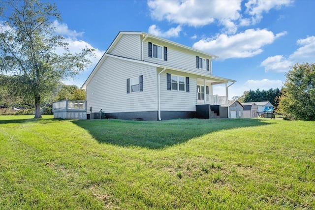 back of property featuring central AC unit and a lawn