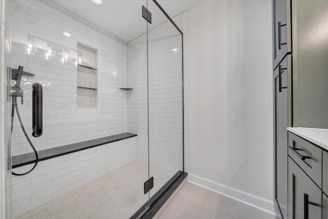 bathroom with an enclosed shower, tile patterned flooring, and vanity