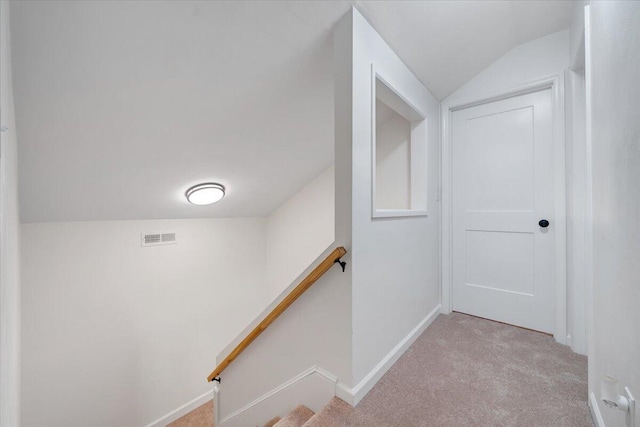 stairs featuring lofted ceiling and carpet