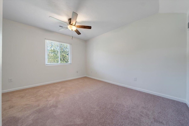 unfurnished room with lofted ceiling, ceiling fan, and light colored carpet