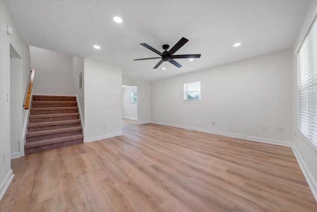 unfurnished living room featuring light wood-type flooring and ceiling fan