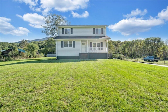 front of property with a front yard, a mountain view, and covered porch