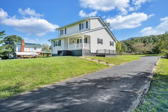 exterior space with a front yard and covered porch