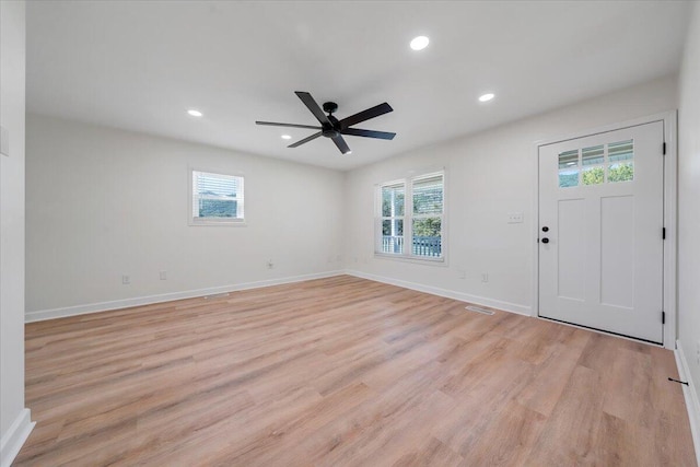 foyer featuring ceiling fan, light wood-type flooring, and plenty of natural light