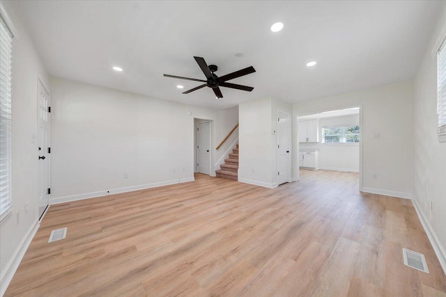 unfurnished living room featuring ceiling fan and light hardwood / wood-style flooring