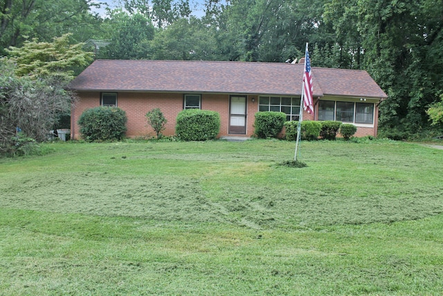 ranch-style home with a front lawn