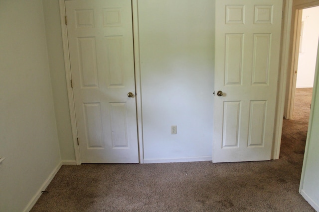 unfurnished bedroom featuring dark colored carpet