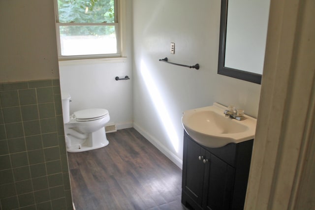 bathroom featuring vanity, hardwood / wood-style floors, and toilet