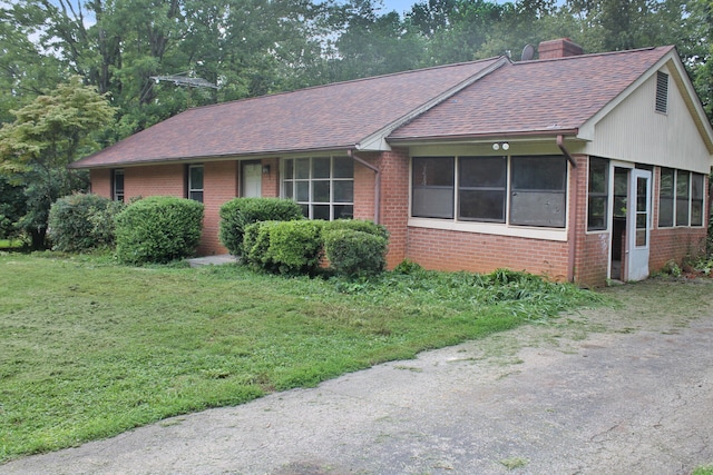 ranch-style home with a front lawn