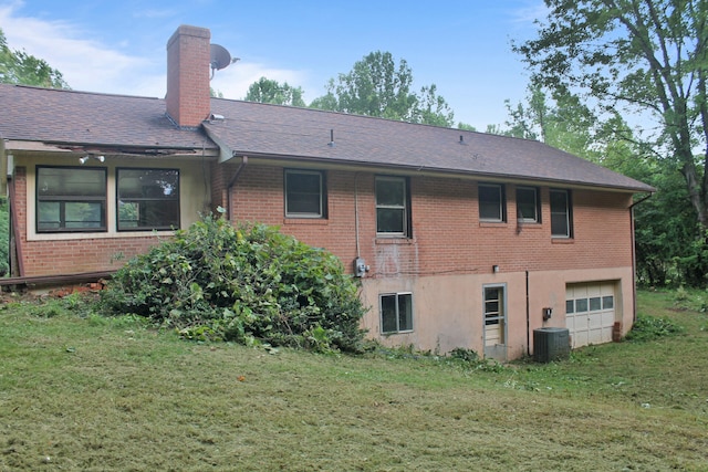 rear view of house featuring cooling unit and a yard