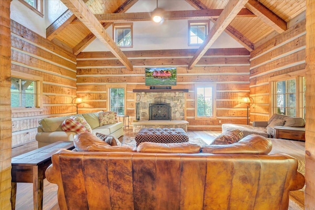 living room with wood-type flooring, beam ceiling, high vaulted ceiling, and a healthy amount of sunlight