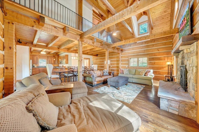 living room with wood ceiling, beamed ceiling, and hardwood / wood-style flooring