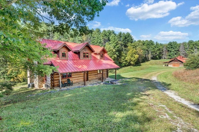 exterior space with a front lawn and central AC