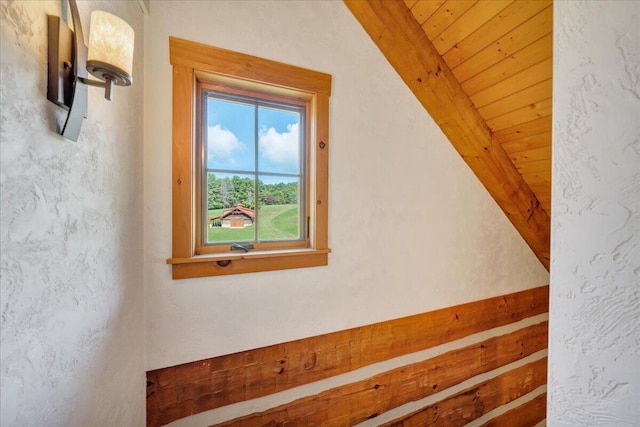 additional living space featuring lofted ceiling with beams and wooden ceiling