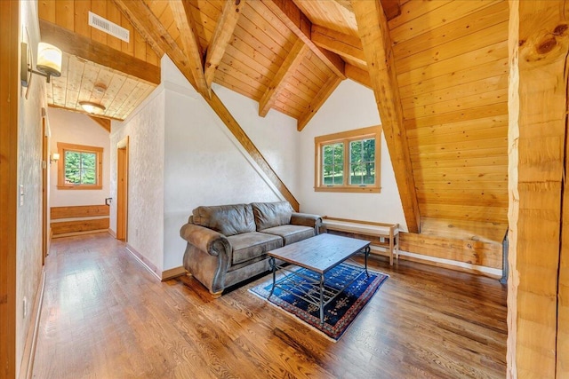 living room with hardwood / wood-style flooring, beamed ceiling, wooden ceiling, and a healthy amount of sunlight