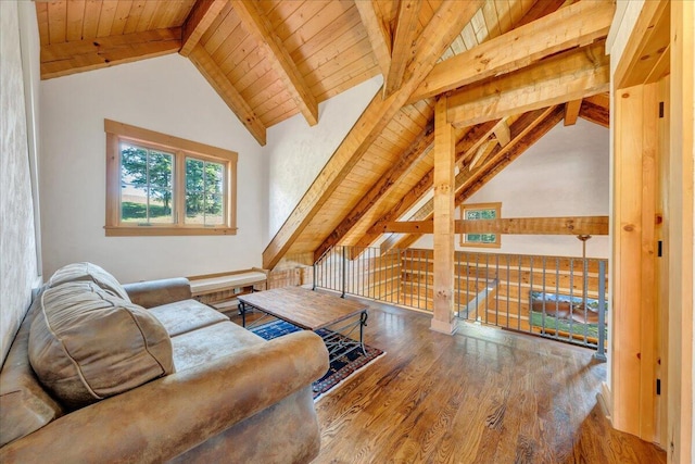 living area with wooden ceiling, wood-type flooring, and lofted ceiling with beams