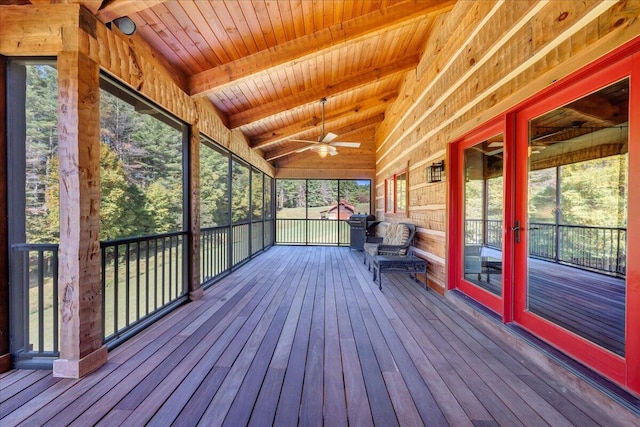 unfurnished sunroom with lofted ceiling with beams, ceiling fan, and wooden ceiling