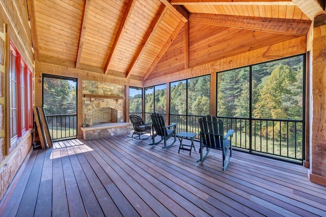 unfurnished sunroom featuring vaulted ceiling with beams and wooden ceiling