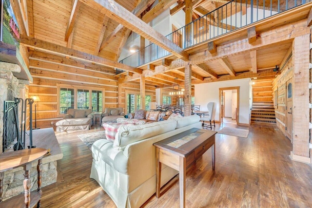 living room with beamed ceiling, hardwood / wood-style floors, high vaulted ceiling, and wooden ceiling