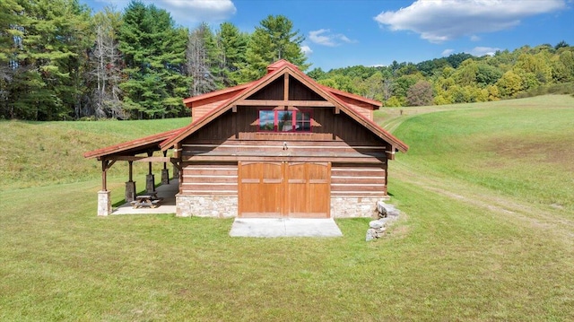 view of outbuilding featuring a yard