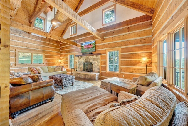 living room with high vaulted ceiling, beamed ceiling, and plenty of natural light