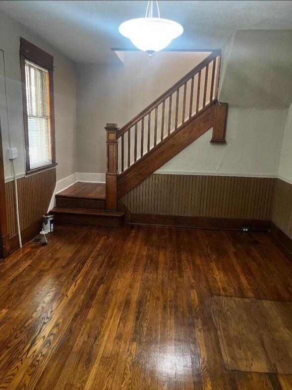 staircase with hardwood / wood-style flooring