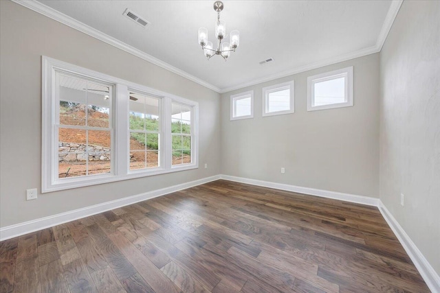 empty room featuring dark hardwood / wood-style floors, ornamental molding, and an inviting chandelier