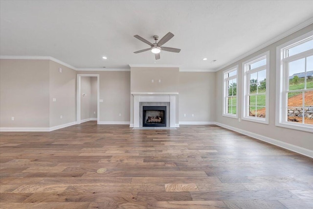 unfurnished living room with ceiling fan, wood-type flooring, and ornamental molding