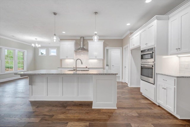 kitchen featuring white cabinetry, dark hardwood / wood-style flooring, wall chimney exhaust hood, and sink