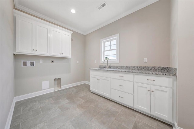 laundry area featuring electric dryer hookup, cabinets, sink, crown molding, and washer hookup