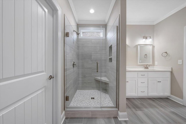 bathroom featuring hardwood / wood-style floors, vanity, a shower with shower door, and crown molding