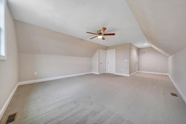 bonus room featuring light colored carpet, vaulted ceiling, and ceiling fan