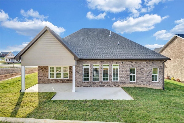 rear view of property with a yard and a patio area