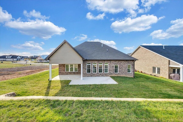 back of property featuring a patio area and a lawn