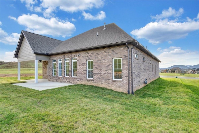 back of house featuring a patio area and a yard