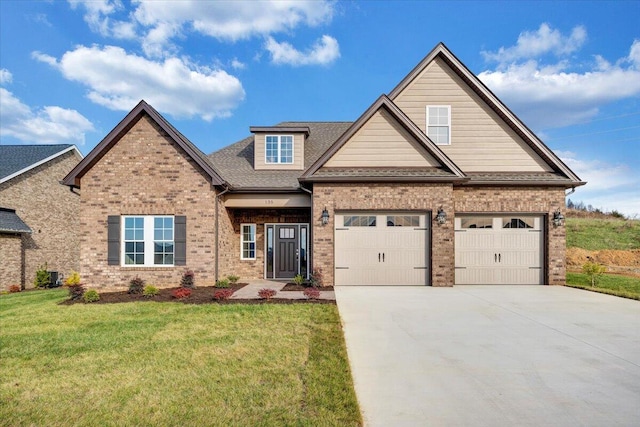 craftsman-style house featuring a garage and a front lawn