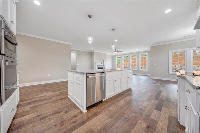 kitchen featuring dark wood-type flooring, white cabinets, crown molding, light stone countertops, and appliances with stainless steel finishes