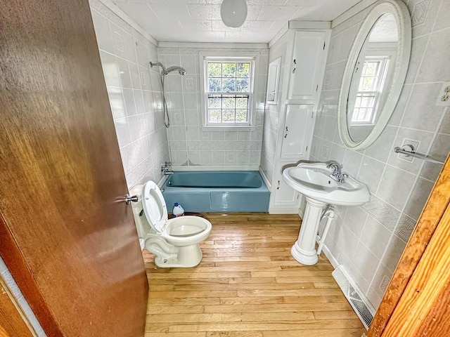 53 Woodberry Ln, Galax, VA 24333 - full bathroom featuring bathing tub / shower combination, hardwood / wood-style floors, toilet, and tile walls