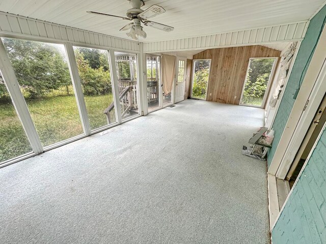 unfurnished sunroom featuring ceiling fan